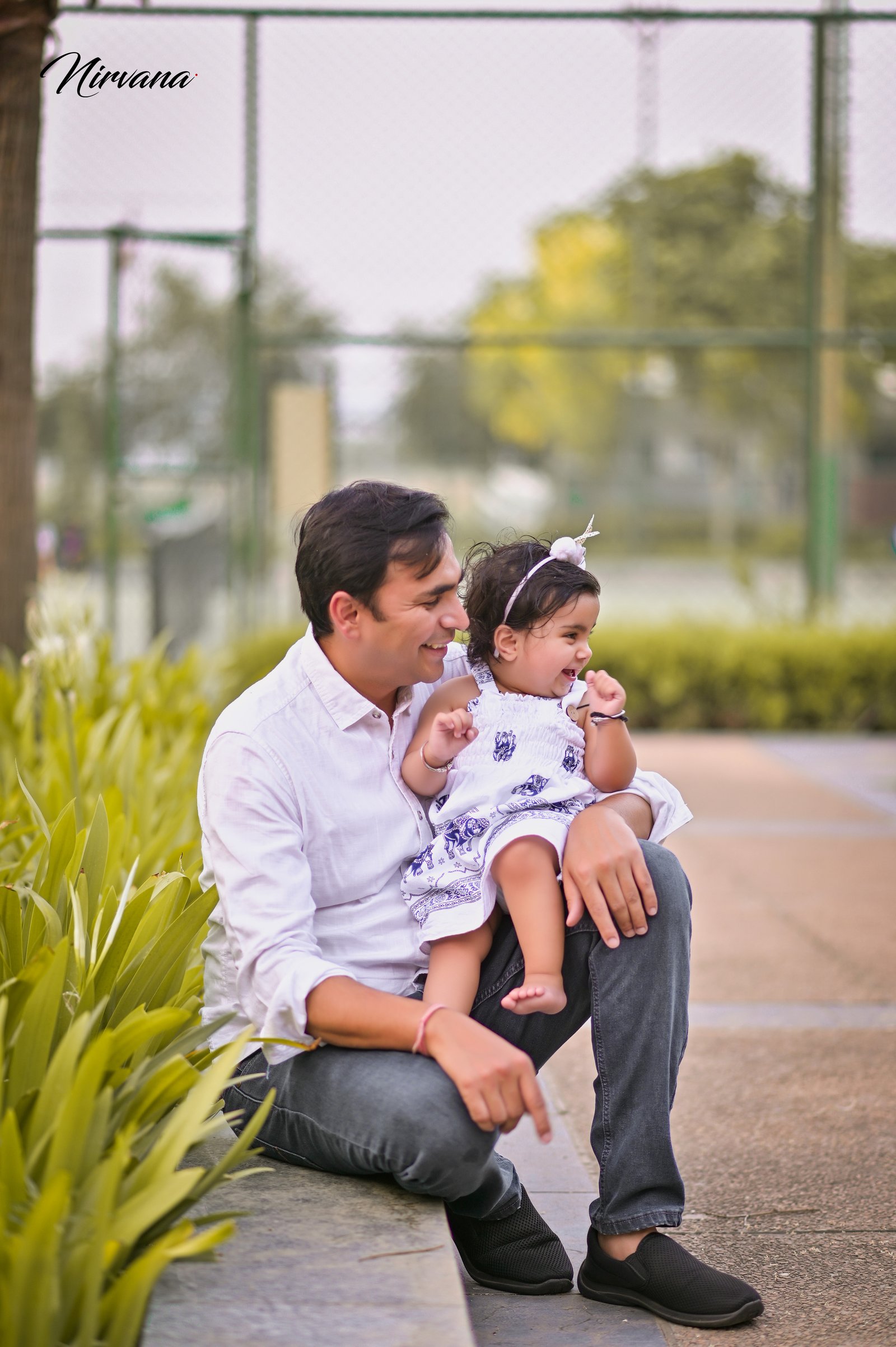 Warm family portrait with baby by Nirvana Photography, image 11
