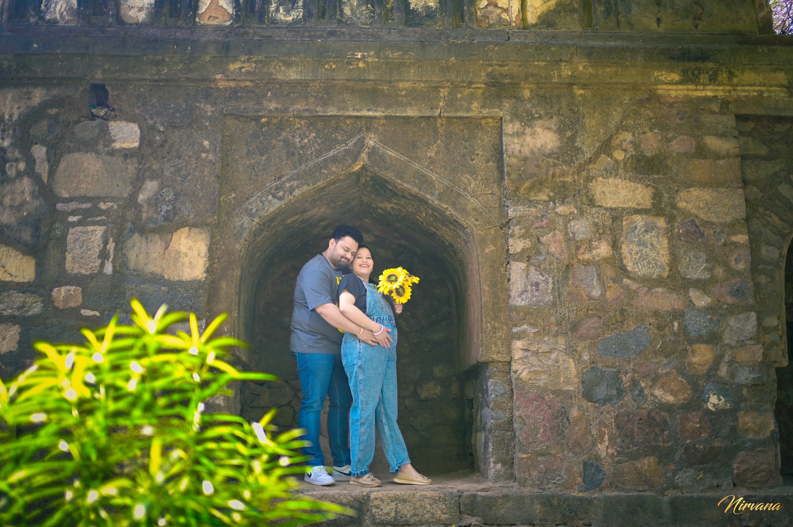 Expecting parents embracing during an outdoor maternity session
