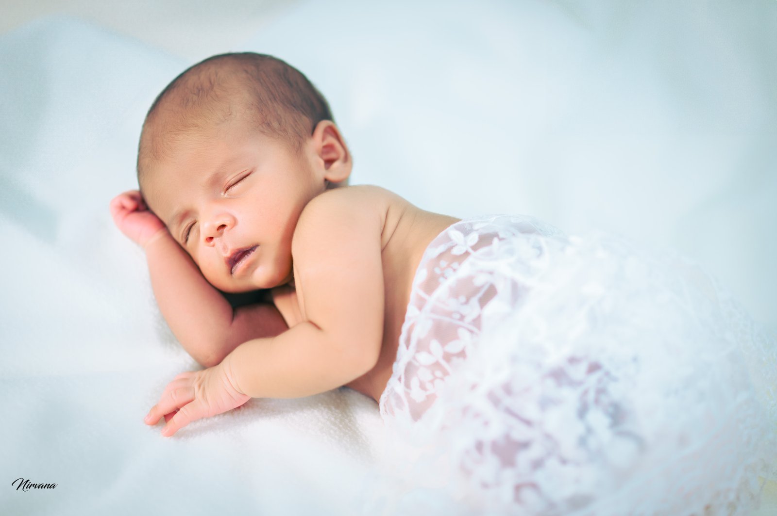 Sleeping newborn posed safely in the Nirvana studio